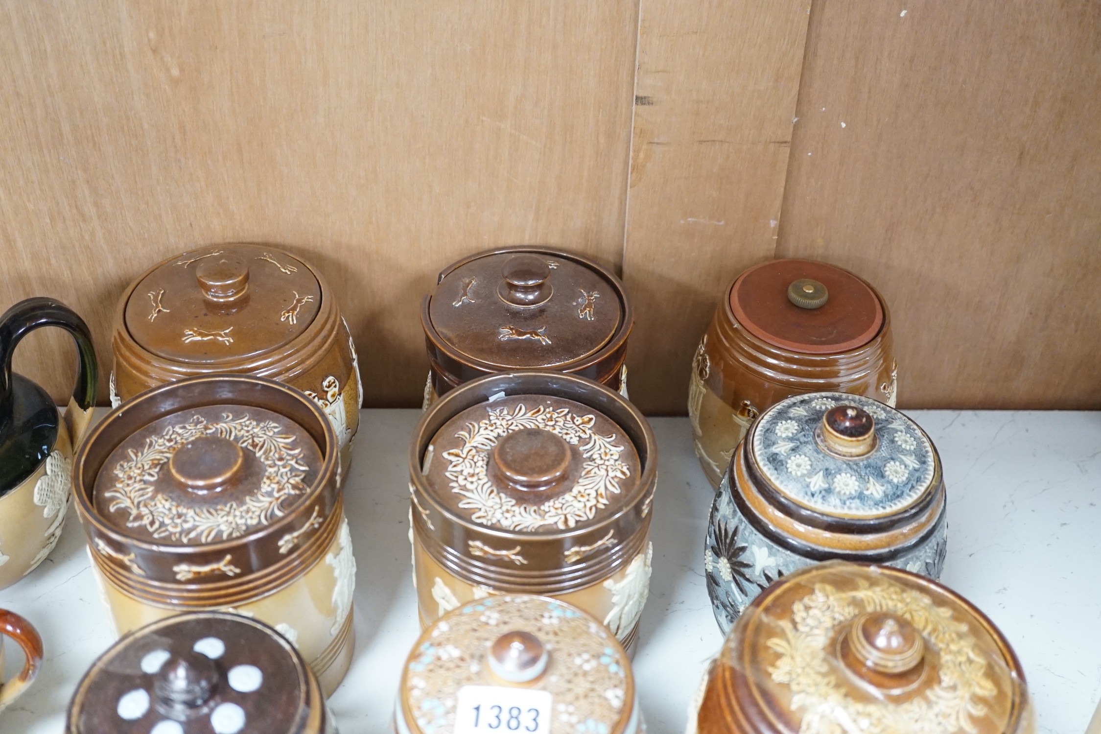 A quantity of Doulton stoneware tobacco jars and jugs